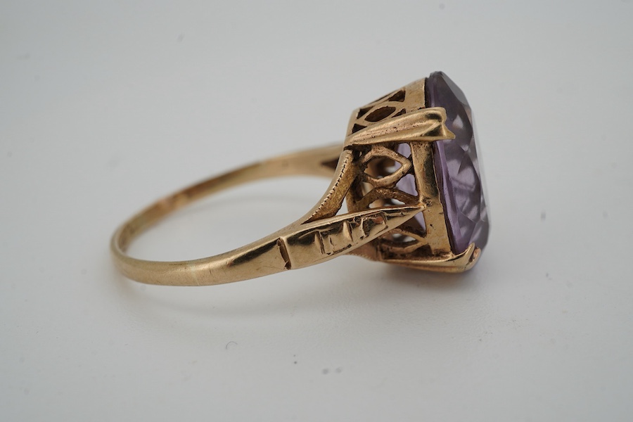 An amethyst ring and a pendant, the ring set with an oval amethyst, mounted in 9ct gold, size N, British hallmarks; the pendant modelled as an archer, length 3.6cm